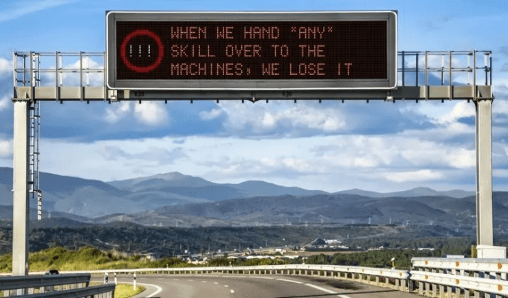 Road sign that reads, "When we hand *any* skill over to the machines, we lose it."